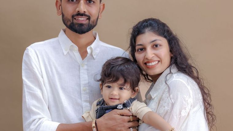 A mother and father holding their baby