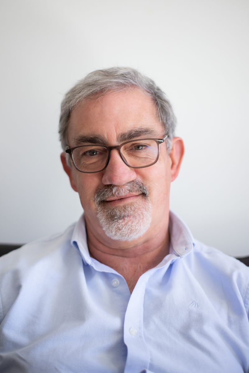 A smiling middle-aged man in glasses