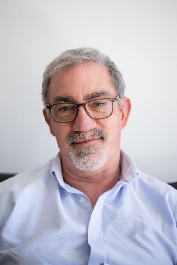 A smiling middle-aged man in glasses
