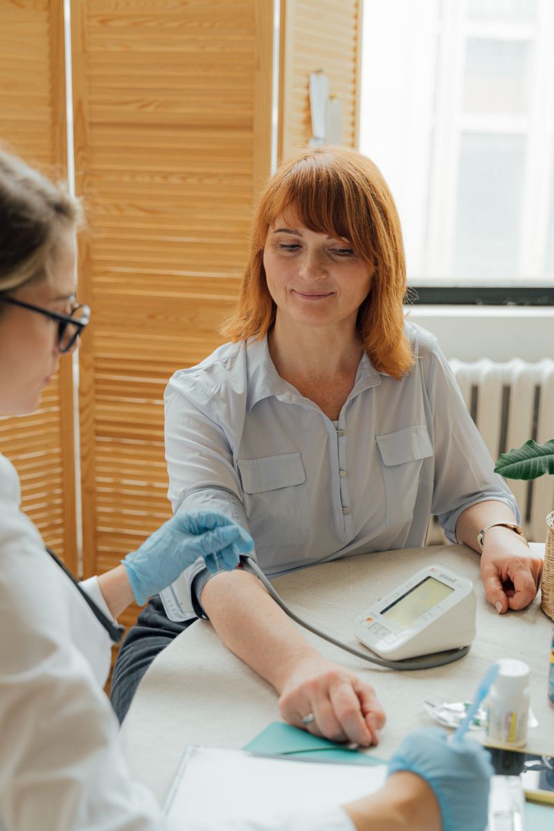A woman having her blood pressure checked
