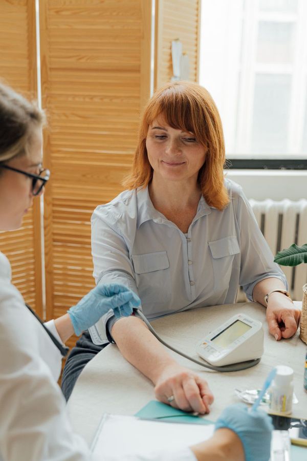 A woman having her blood pressure checked