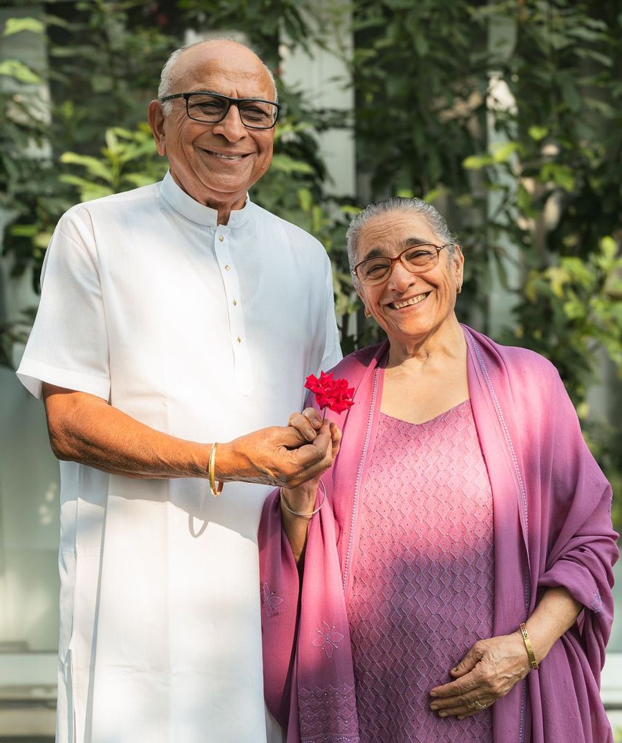 An older couple smiling together outdoors
