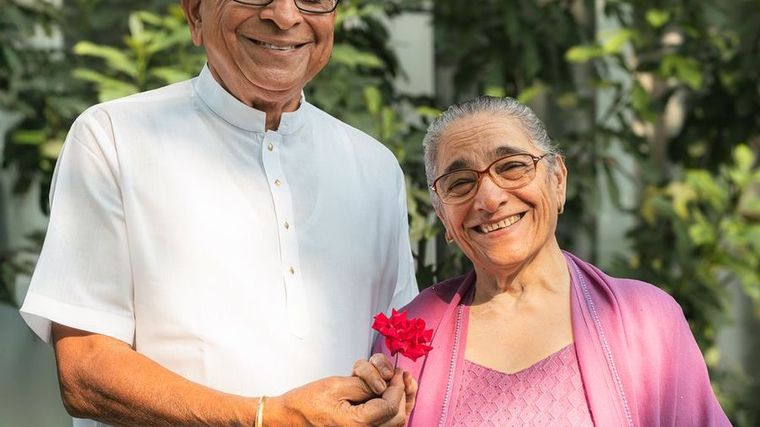 An older couple smiling together outdoors