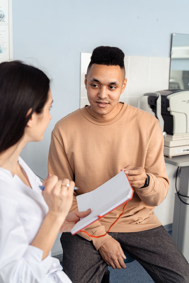 A young man talking with a doctor