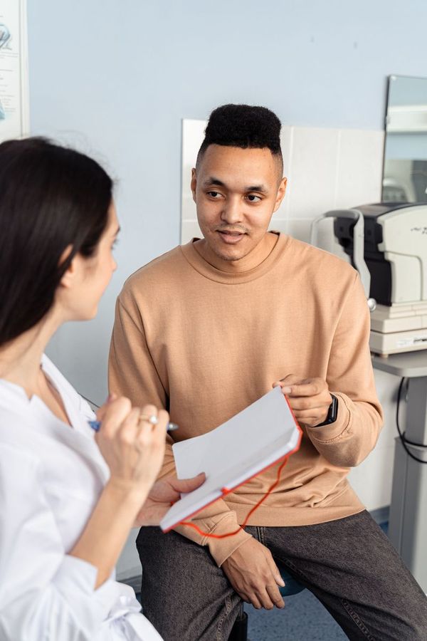 A young man talking with a doctor