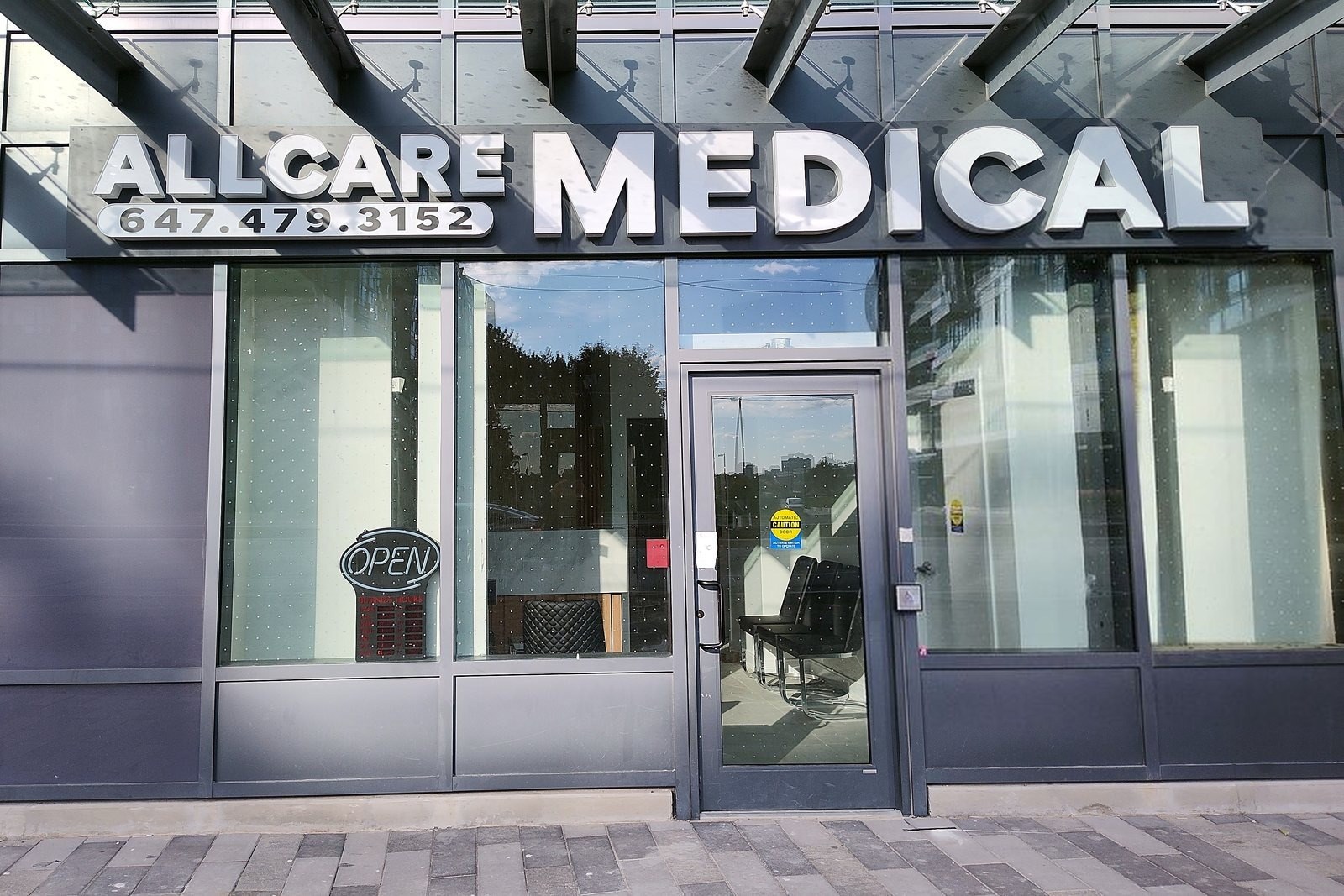 The All Care Medical storefront at 5105 Hurontario Street, with the OPEN sign lit in the window