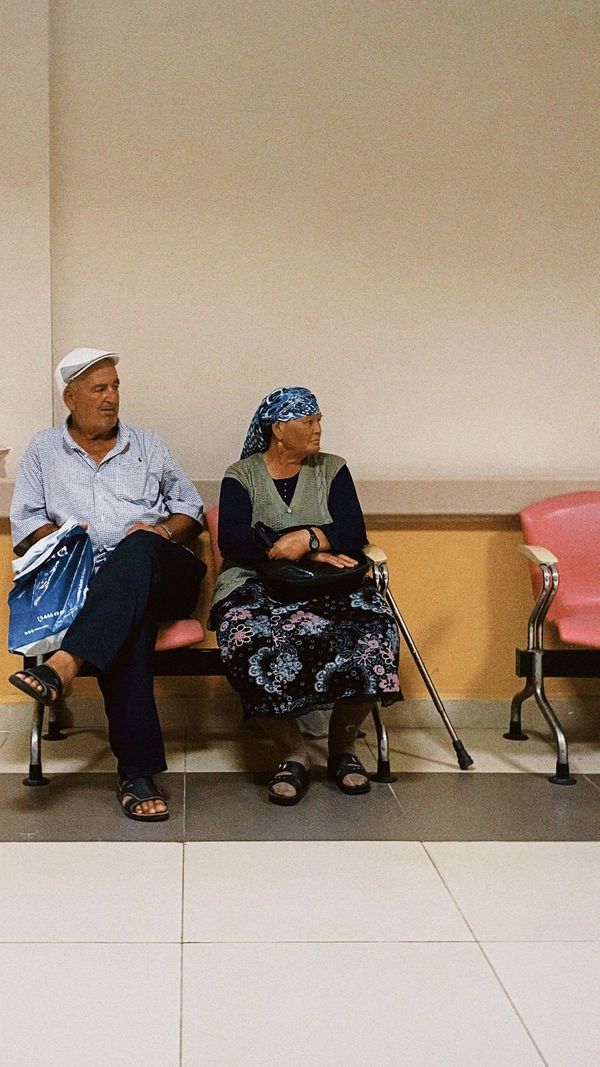 An older couple waiting in a clinic