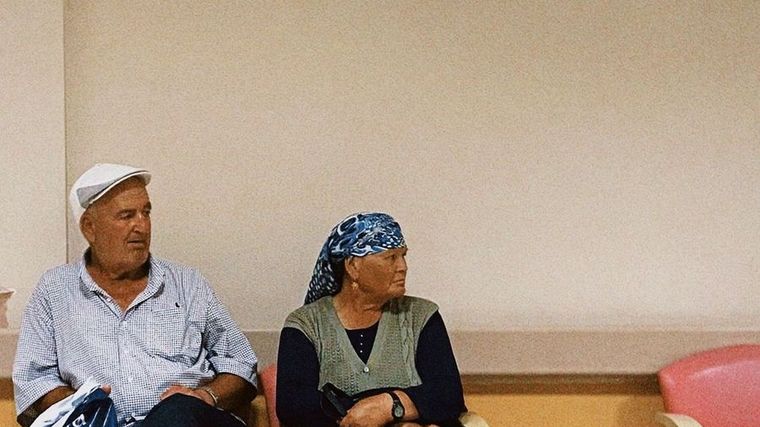 An older couple waiting in a clinic
