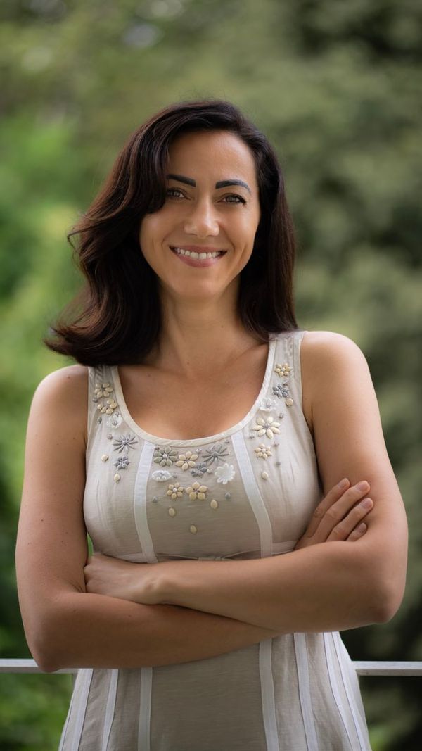 A smiling woman in her forties outdoors